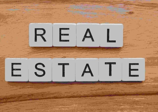 Real Estate Title on wood background